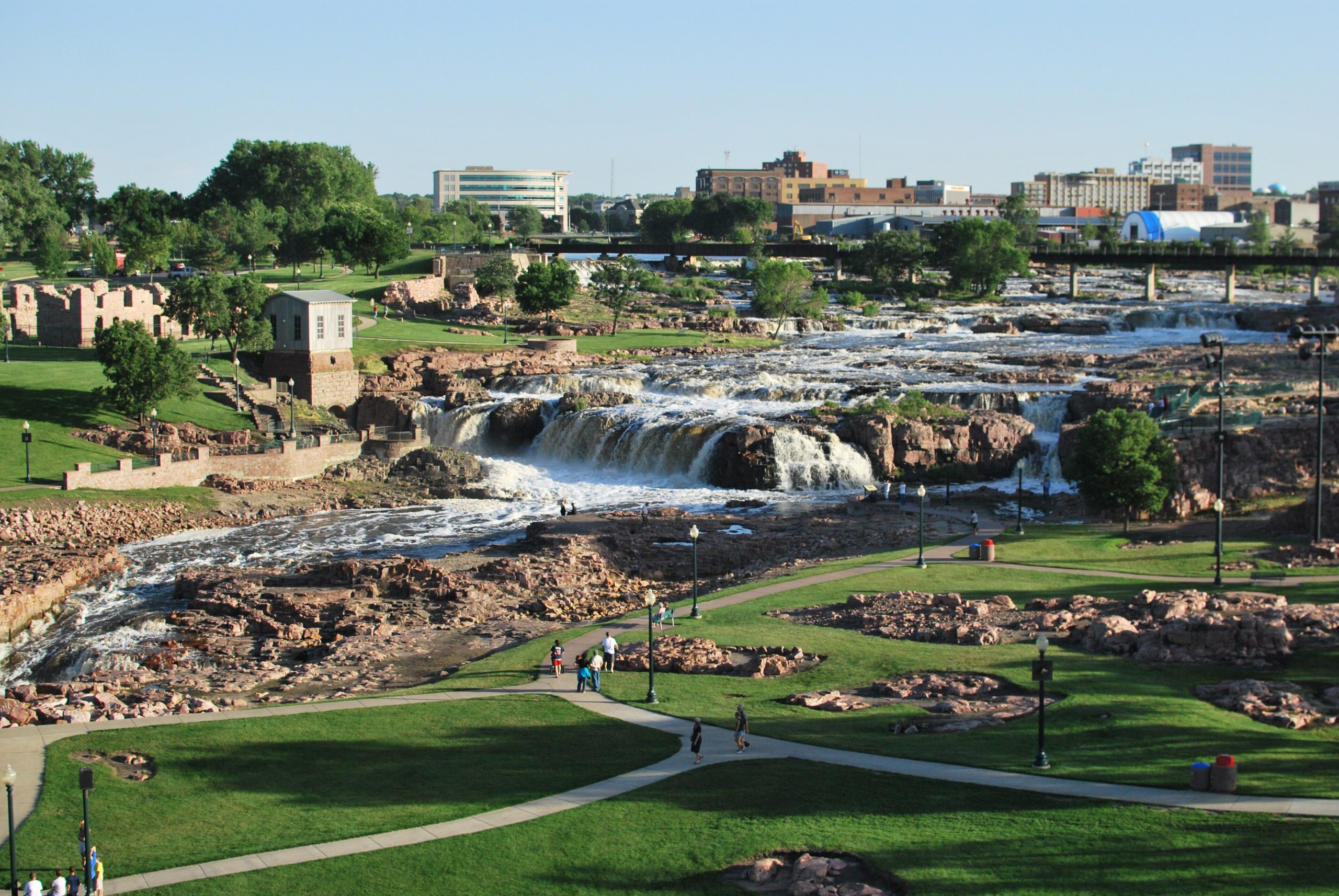 Aerial image of falls during spring, the water level is high and the grass is vibrant green.
